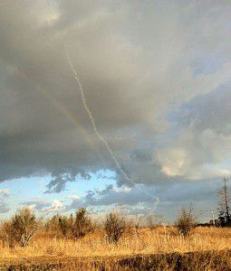 Smoke from rocket near rainbow around Gan Yavneh, Sunday Photo Yogev Shmuelevitch