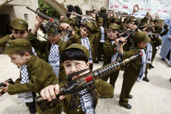 Palestinian boys dressed in uniforms of Palestinian security forces and holding plastic toy guns take part during a rally marking “Nakba” in the West Bank city of Nablus May 15, 2011. Palestinians on Sunday mark the “Nakba”, or catastrophe, to commemorate the expulsion or fleeing of some 700, 000 Palestinians from their homes in the war that led to the founding of Israel in 1948. (REUTERS/Abed Omar Qusini)